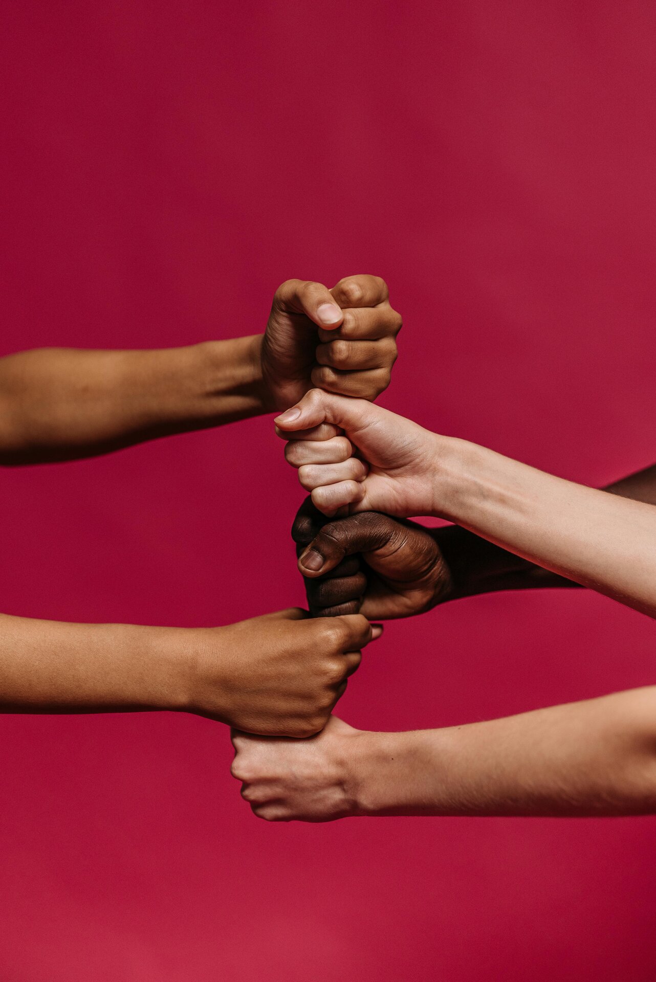 Diverse hands united in collaboration symbolizing inclusive leadership